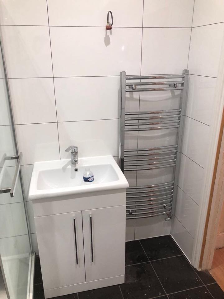 Fitted bathroom with basin unit and chrome towel radiator