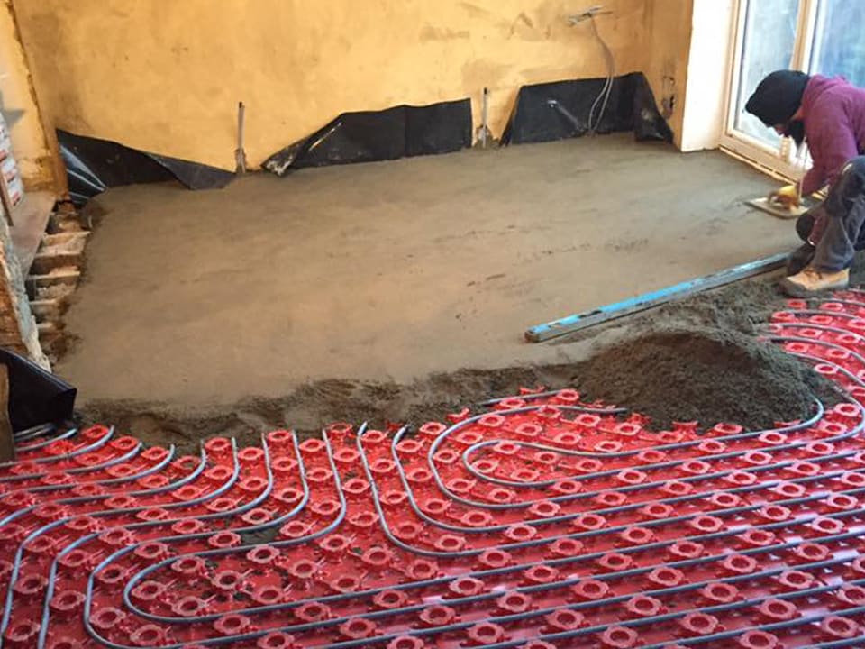 Red underfloor heating pipework laid before screeding