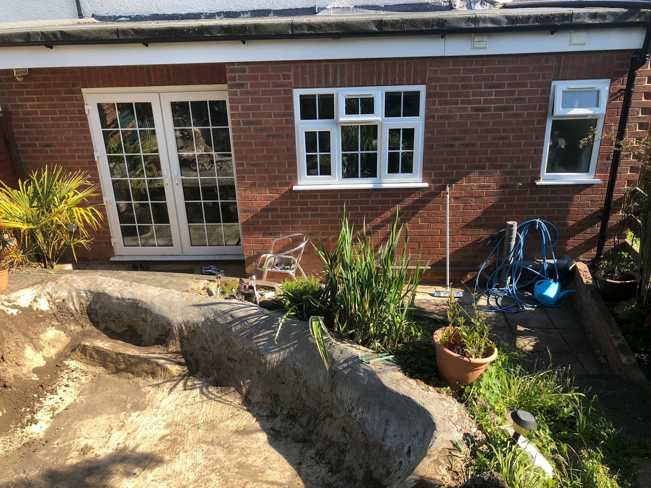 Brick house with French doors and rockery garden